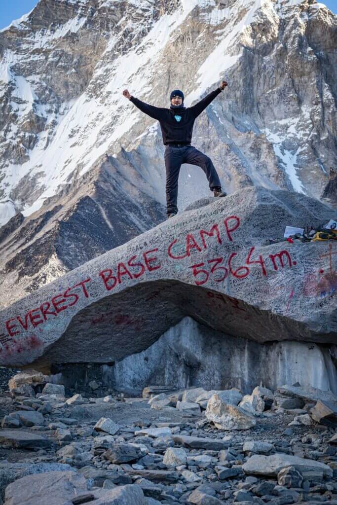 A man stands at Moutn Everest Basecamp.