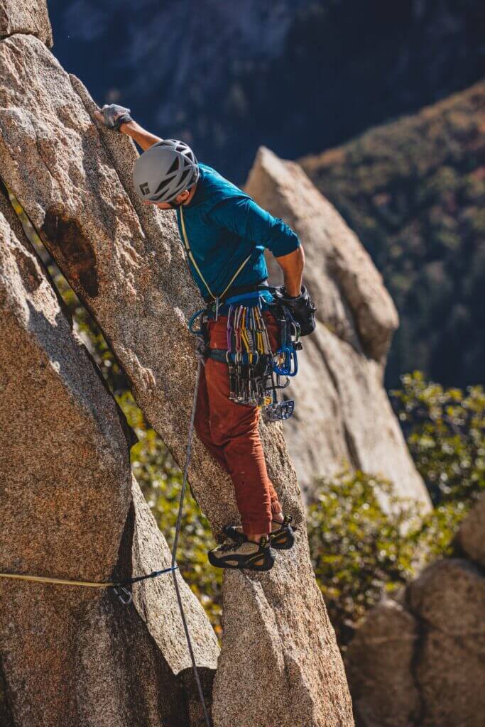 A rock climber wearing trad gear 