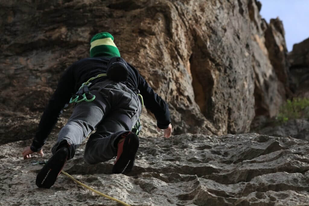 A sport climber works their way up a sport climb.